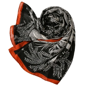 Elegant floral scarf with black leaf patterns and orange borders on a white backdrop