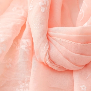 Close-up of light pink cotton linen scarf featuring delicate floral and butterfly prints