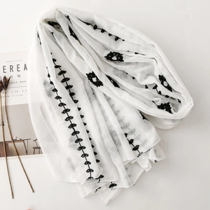 Detailed embroidery on white breathable linen scarf with floral pattern details