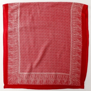 Detail of red and white textured knit scarf with distinctive pleated edge finish