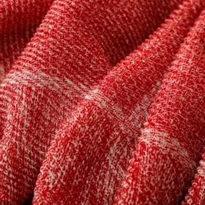 Macro shot of red and white woven texture with soft knit patterns on a warm scarf