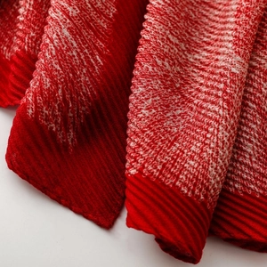 Macro detail of red and white pleated fabric texture with elegant wavy pattern