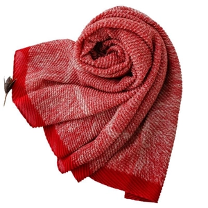 Soft knit scarf with red and white textured weave in a decorative floral scroll shape