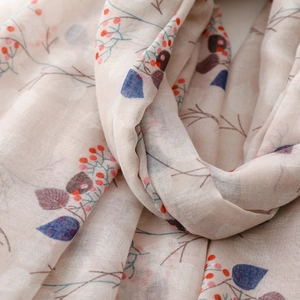 Close-up of lightweight berry and leaf print scarf with breathable woven texture