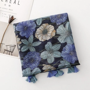 Macro detail of blue floral print scarf with elegant gradient tassels and soft texture