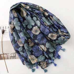 Detail of vintage blue floral scarf showing delicate tassels and lightweight fabric texture