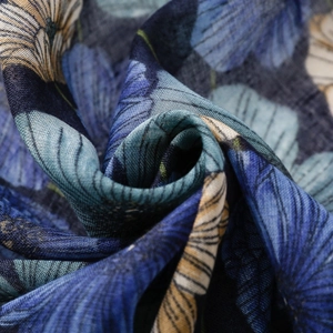Macro shot of blue floral print scarf showing detailed fabric texture and lightweight drape