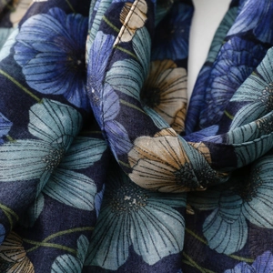 Close-up of blue floral scarf showing breathable fabric texture and fine edge stitching