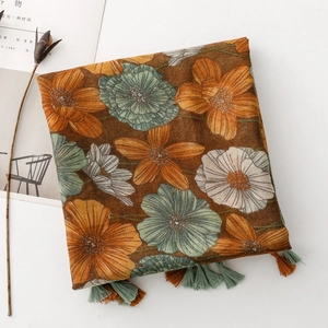 Detail of floral print scarf with bicolored tassels and retro bohemian patterns