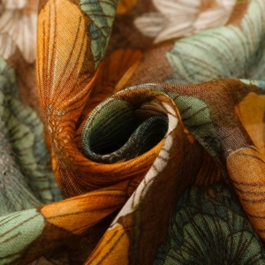 Macro detail of vintage floral scarf fabric showing soft drape and tight weave texture