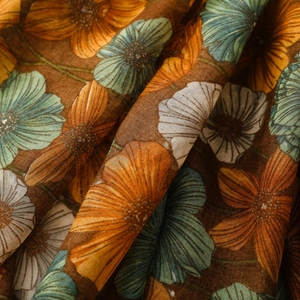 Detail of blue floral print on vintage scarf fabric with elegant draped texture