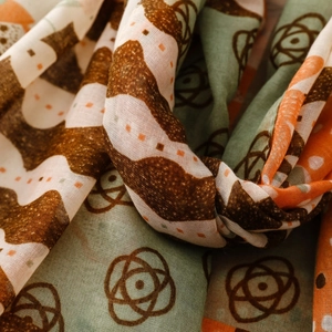 Close-up of geometric bohemian print on soft cotton-linen blend scarf in warm tones
