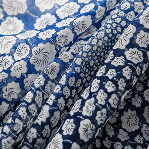 Macro detail of blue and white floral pattern on soft fabric with woven texture
