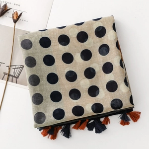 Detail of polka dot scarf with colorful fringes and breathable cotton-linen texture