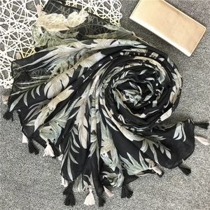 Retro banana leaf print cotton linen beach shawl with fringe edges on grey background