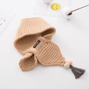 Knitted beige children scarf with colorful pom-poms, tassels, and Hand Made label