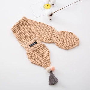 Beige knitted scarf with colorful pom-poms, tassels, and a handmade label for kids