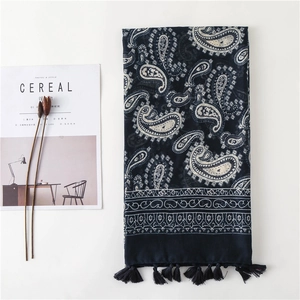 Ethnic navy blue paisley scarf with tassels displayed on a minimalist lifestyle setting