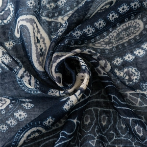 Close-up of navy blue paisley scarf showing soft fabric texture and detailed patterns