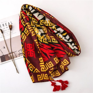 Ethnic style cotton linen shawl with zebra pattern and red tassel fringe on white background