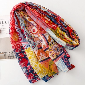 Bohemian floral scarf with tassels featuring vibrant mixed color blocks on a white backdrop