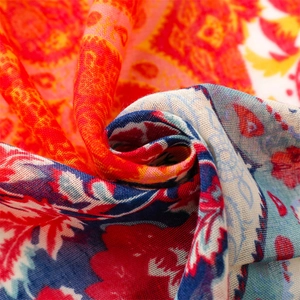 Detailed close-up of vibrant paisley totem print fabric with intricate weave texture