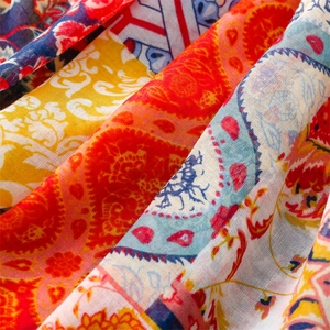 Macro view of paisley totem patterns and soft colorful fabric texture on the shawl