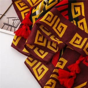 Close-up of diamond zebra pattern scarf with bright red tassels and ethnic geometric style