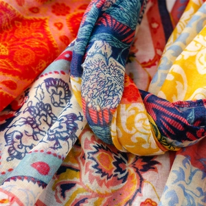Detail shot of colorful bohemian floral shawl with textured breathable fabric
