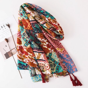 Detailed shot of ethnic floral print shawl with dark red fringe and bohemian patterns