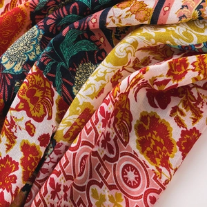 Detailed view of colorful bohemian floral patterns on breathable fabric shawl