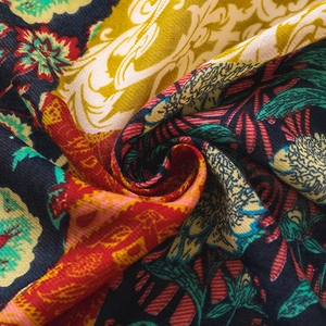 Macro detail of colorful retro totem floral patterns on a lightweight summer shawl fabric