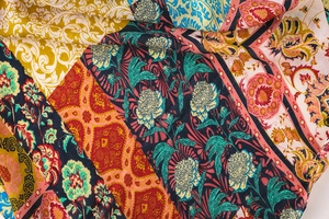 Close-up of Bohemian patchwork scarf with ethnic floral patterns and paisley details