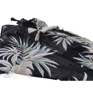Retro tropical palm leaf print beach shawl with decorative tassels on white background