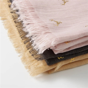 Winter scarves in pink, grey and beige with golden reindeer print and tassel edges