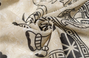Close-up of cotton linen scarf showing ethnic elephant print and woven fiber texture