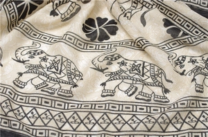 Detailed view of elephant pattern print on breathable cotton linen scarf with soft texture