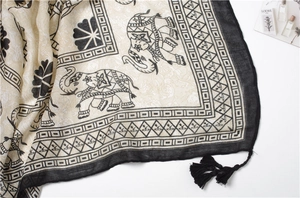 Macro shot of ethnic elephant print cotton linen scarf with elegant black tassels