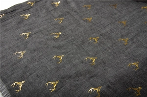Detail of dark grey cotton linen scarf with golden deer antler foil print and frayed edges
