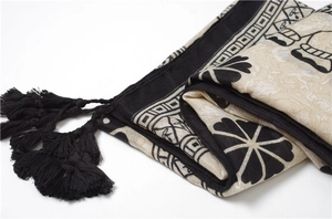 Detail of cotton linen scarf showing ethnic elephant print and black tassel fringe
