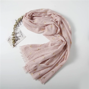 Detail of pink reindeer gold foil scarf with fringe edges and natural linen texture