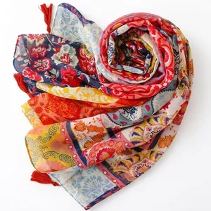 Bohemian floral paisley scarf with red tassels in vibrant multicolored ethnic print