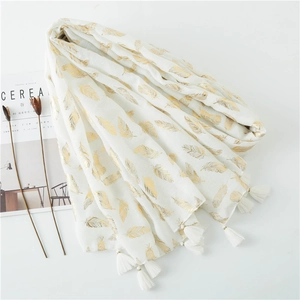 White long scarf with gold metallic feather print and tassels, elegant linen texture shawl
