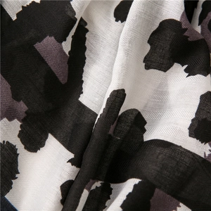 Macro shot of cotton linen scarf showing leopard print and herringbone texture weave