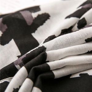 Close-up of black and white abstract leopard print on soft cotton linen scarf fabric