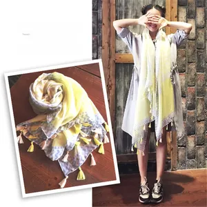 Detail of yellow and grey wave pattern cotton scarf with decorative tassels