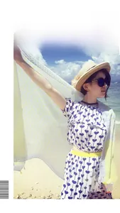 Detail view of a yellow geometric pattern beach shawl and straw hat for summer seaside