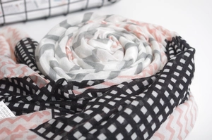 Detail of cotton scarf featuring lemon yellow zigzag patterns and fringe textures