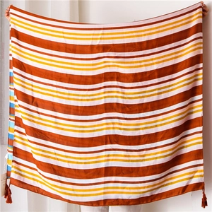 Detail of colorful striped cotton linen scarf with soft fringe edges and woven texture