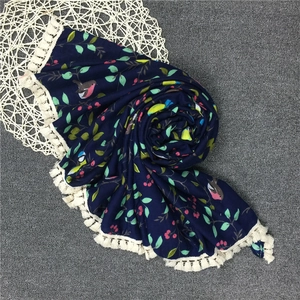 Vintage navy blue scarf featuring bird and leaf prints with elegant white tassels
